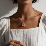 princess cut necklace on model, crystal solitaire pendant lifestyle, gold box chain necklace, square cut crystal necklace, statement pendant on model, layering necklace jewelry