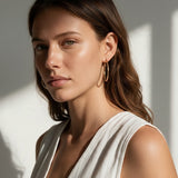 gold hoop earrings on model, textured gold hoops, thin endless hoop earrings, diamond-cut hoop earrings, lightweight hoop earrings, medium gold hoops, minimalist gold hoops, everyday hoop earrings, sleeper hoops, twist hoop earrings, women’s gold hoops, elegant everyday earrings