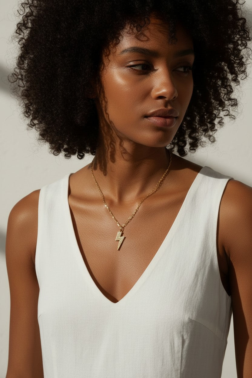 lightning bolt pendant necklace, pave crystal lightning bolt, gold bolt charm necklace, paper clip chain necklace, statement pendant detail, crystal encrusted pendant, edgy gold necklace, lightning bolt jewelry