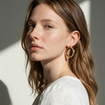 gold flat hoop earrings on model, wide band hoop earrings, medium gold hoop earrings, textured gold hoops, polished gold hoop earrings, modern hoop earrings, statement hoops, everyday gold hoops, minimalist hoop earrings, hoop earrings for bob hair, gift for her, linen summer style jewelry