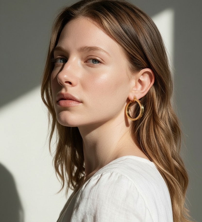 gold flat hoop earrings on model, wide band hoop earrings, medium gold hoop earrings, textured gold hoops, polished gold hoop earrings, modern hoop earrings, statement hoops, everyday gold hoops, minimalist hoop earrings, hoop earrings for bob hair, gift for her, linen summer style jewelry