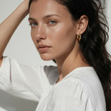 chunky gold huggie hoop earrings, gold dome hoop earrings, thick gold hoops, small gold hoop earrings, everyday gold hoops, polished gold huggies, lightweight chunky hoops, minimalist gold earrings, classic hoop earrings, earrings for stacking, gift for her, gold hoop earrings on model