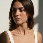 layered gold ball chain necklace, dainty bead chain necklace on model, faceted gold chain, thin gold layering necklaces, two layer gold necklace, minimalist gold necklace, delicate gold chain, collarbone necklace, everyday gold necklace, sparkly gold bead chain, women’s layering necklace, summer gold necklace