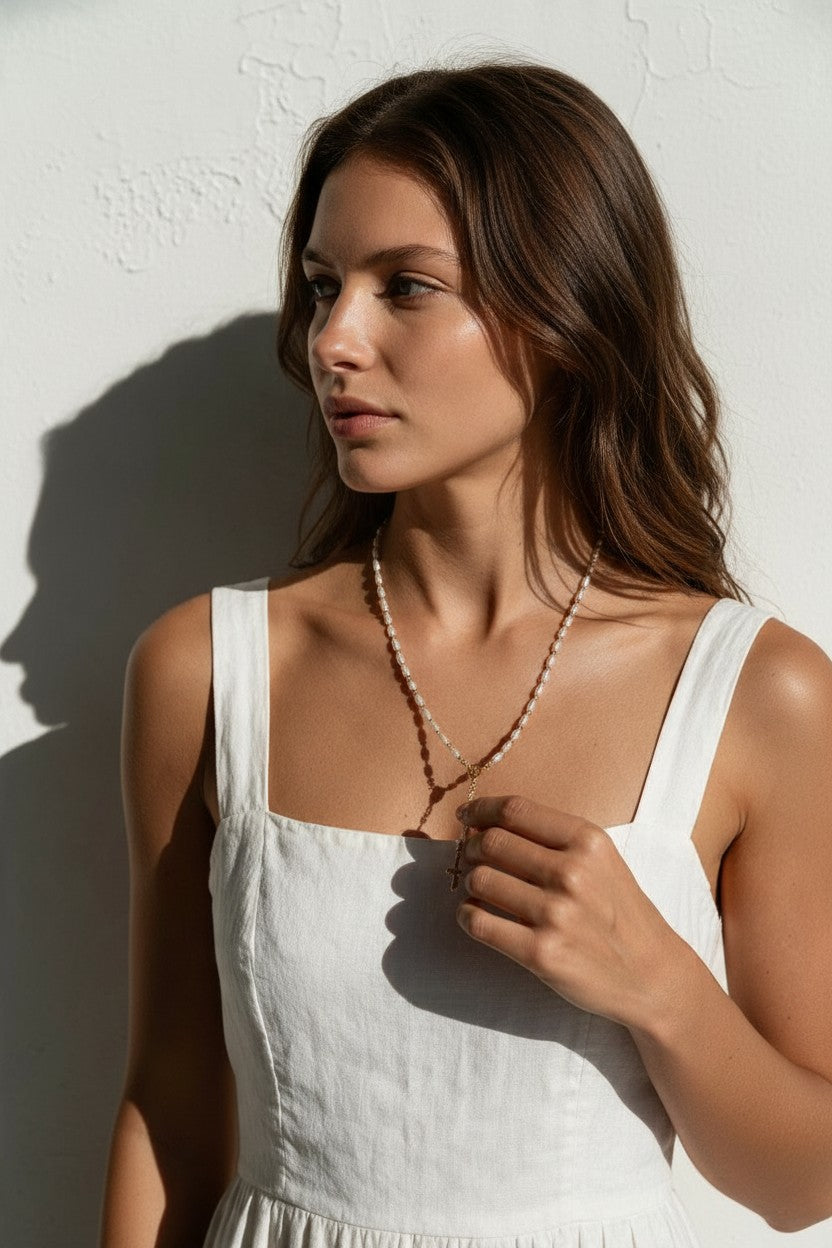 pearl rosary necklace on model, freshwater pearl rosary necklace, gold bead rosary necklace, rosary style necklace, pearl cross necklace, Catholic jewelry, religious necklace, first communion gift, confirmation gift, baptism gift, vintage-style pearl necklace, collarbone necklace, gift for her