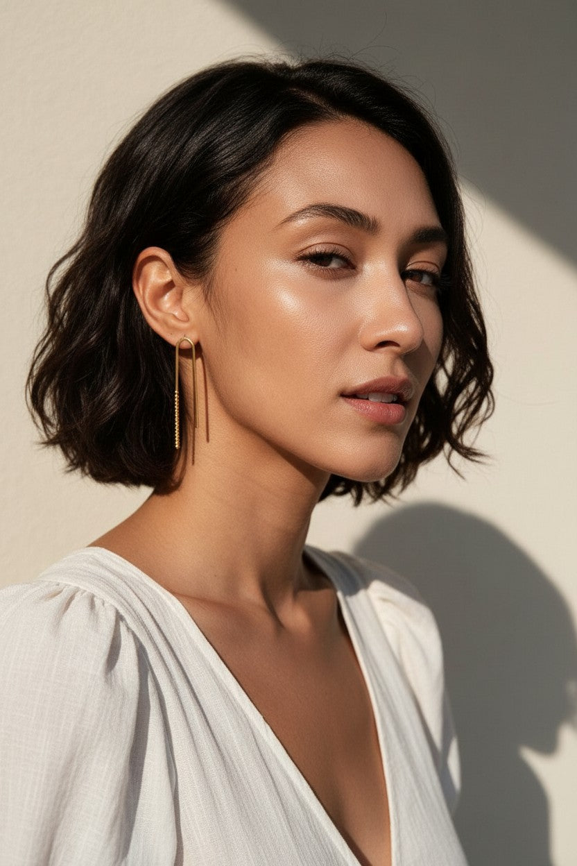 gold U-shaped drop earrings on model, long gold bar earrings, hairpin earrings, elongated arch earrings, beaded drop earrings, minimalist gold earrings, modern statement earrings, linear drop earrings, earrings for short hair, lightweight gold earrings, gift for her, editorial jewelry