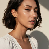 gold U-shaped drop earrings on model, long gold bar earrings, hairpin earrings, elongated arch earrings, beaded drop earrings, minimalist gold earrings, modern statement earrings, linear drop earrings, earrings for short hair, lightweight gold earrings, gift for her, editorial jewelry