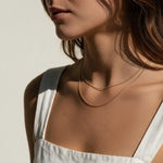 layered gold ball chain necklace, dainty bead chain necklace on model, faceted gold chain, thin gold layering necklaces, two layer gold necklace, minimalist gold necklace, delicate gold chain, collarbone necklace, everyday gold necklace, sparkly gold bead chain, women’s layering necklace, summer gold necklace