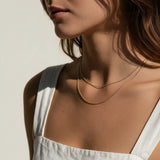 layered gold ball chain necklace, dainty bead chain necklace on model, faceted gold chain, thin gold layering necklaces, two layer gold necklace, minimalist gold necklace, delicate gold chain, collarbone necklace, everyday gold necklace, sparkly gold bead chain, women’s layering necklace, summer gold necklace