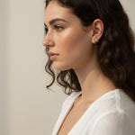 gold pyramid hoops on model, layered ear stack, textured huggie hoop earrings, simple gold ear cuff, gold hoop and cuff set, ear stacking gold jewelry, minimalist ear cuff pairing, edgy gold hoops worn