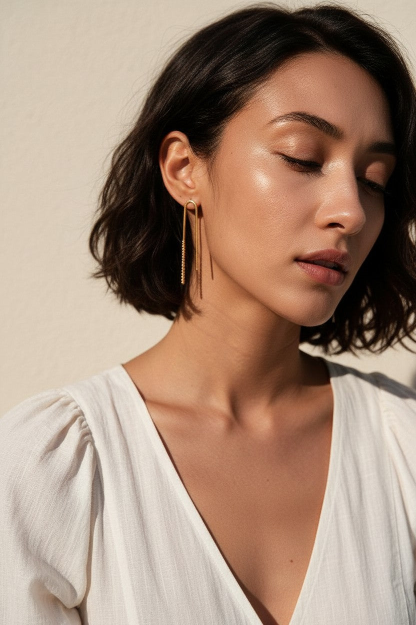 gold U-shaped drop earrings on model, long gold bar earrings, hairpin earrings, elongated arch earrings, beaded drop earrings, minimalist gold earrings, modern statement earrings, linear drop earrings, earrings for short hair, lightweight gold earrings, gift for her, editorial jewelry