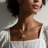 princess cut necklace on model, crystal solitaire pendant lifestyle, gold box chain necklace, square cut crystal necklace, statement pendant on model, layering necklace jewelry