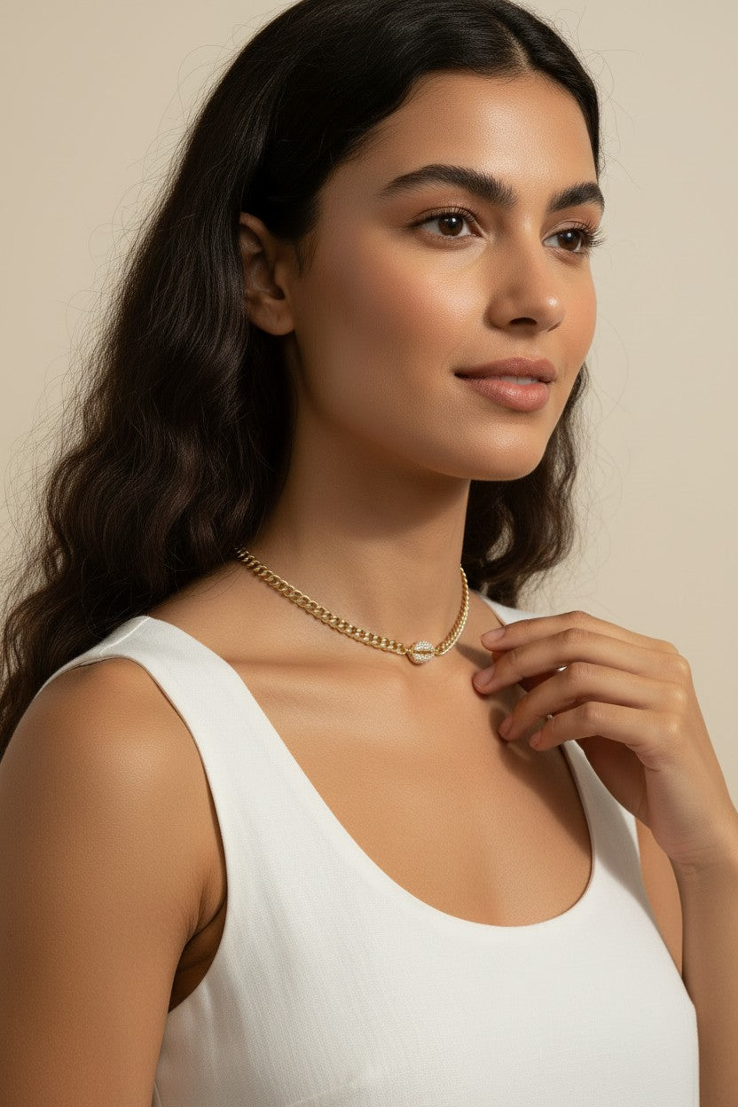 cowrie shell choker on model, gold chain choker how it fits, layered curb chain choker, pavé crystal shell necklace worn, gold choker neck length, cowrie shell jewelry styled