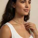 cowrie shell choker on model, gold chain choker how it fits, layered curb chain choker, pavé crystal shell necklace worn, gold choker neck length, cowrie shell jewelry styled