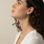 gold pyramid hoops on model, layered ear stack, textured huggie hoop earrings, simple gold ear cuff, gold hoop and cuff set, ear stacking gold jewelry, minimalist ear cuff pairing, edgy gold hoops worn