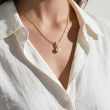 pearl necklace and earring set, pearl drop pendant necklace, pearl drop earrings, bridal pearl jewelry set, gold pearl pendant on model, classic pearl jewelry, pearl and crystal earrings, matching necklace and earring set, wedding jewelry set, elegant pearl jewelry, gift jewelry set for her, women’s pearl jewelry set
