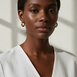 mini dome hoop earrings, small gold hoops on model, chunky mini hoops, rounded gold earrings, everyday small hoops, polished dome earrings, compact gold hoops, minimalist statement earrings