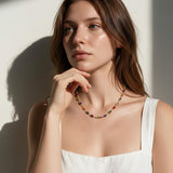 rainbow station necklace on model, colorful gemstone necklace, multicolor bezel necklace, gold station necklace, dainty colorful necklace, jewel tone necklace, emerald cut crystal necklace, summer layering necklace, collarbone length necklace, minimalist color necklace, white linen outfit jewelry, women’s rainbow necklace