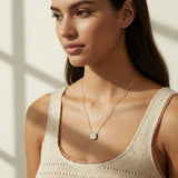 gold paperclip chain necklace, square halo pendant necklace, crystal pendant necklace on model, princess cut pendant necklace, pavé halo necklace, dainty gold necklace, gold-tone layering necklace, collarbone necklace, everyday gold necklace, minimalist pendant necklace, gift for her jewelry, scoop neck necklace
