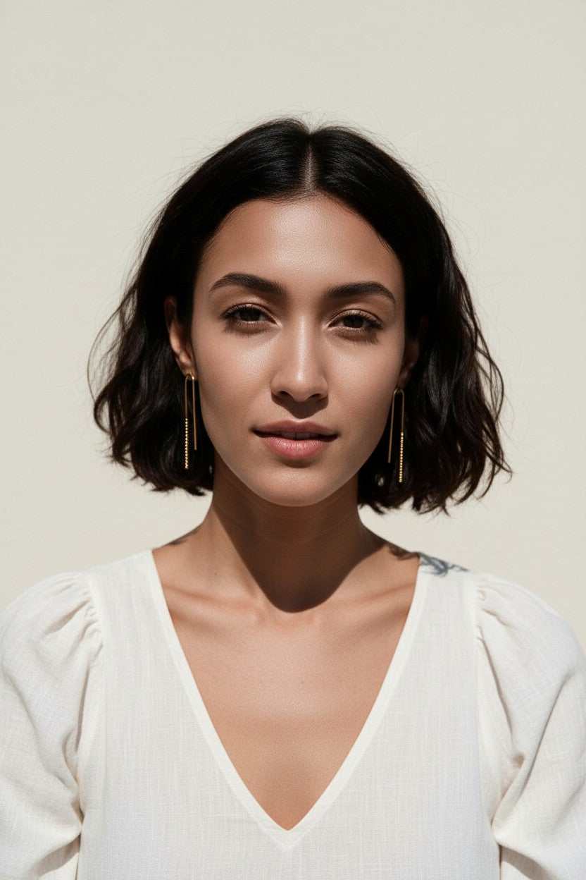 gold U-shaped drop earrings on model, long gold bar earrings, hairpin earrings, elongated arch earrings, beaded drop earrings, minimalist gold earrings, modern statement earrings, linear drop earrings, earrings for short hair, lightweight gold earrings, gift for her, editorial jewelry