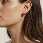chunky gold hoop earrings, dome hoop earrings on model, puffy gold earrings, statement gold earrings, sculptural gold hoops, minimalist chunky earrings, high shine gold earrings, gold earrings close-up