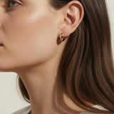 chunky gold hoop earrings, dome hoop earrings on model, puffy gold earrings, statement gold earrings, sculptural gold hoops, minimalist chunky earrings, high shine gold earrings, gold earrings close-up