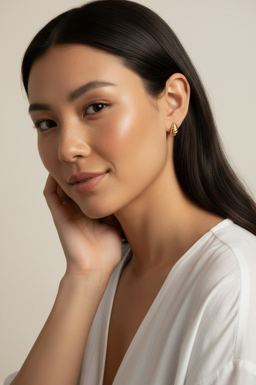 ribbed gold hoop earrings, fluted gold dome earrings, textured gold huggie hoops, ribbed earrings on model, gold hoop earrings close-up, sculptural gold earrings, minimalist ribbed hoops, everyday gold dome earrings