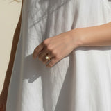 gold pearl ring worn, pearl ring on hand fit, gold filled ring lifestyle photo, minimalist pearl ring styled, freshwater pearl ring close-up, domed pearl ring on finger