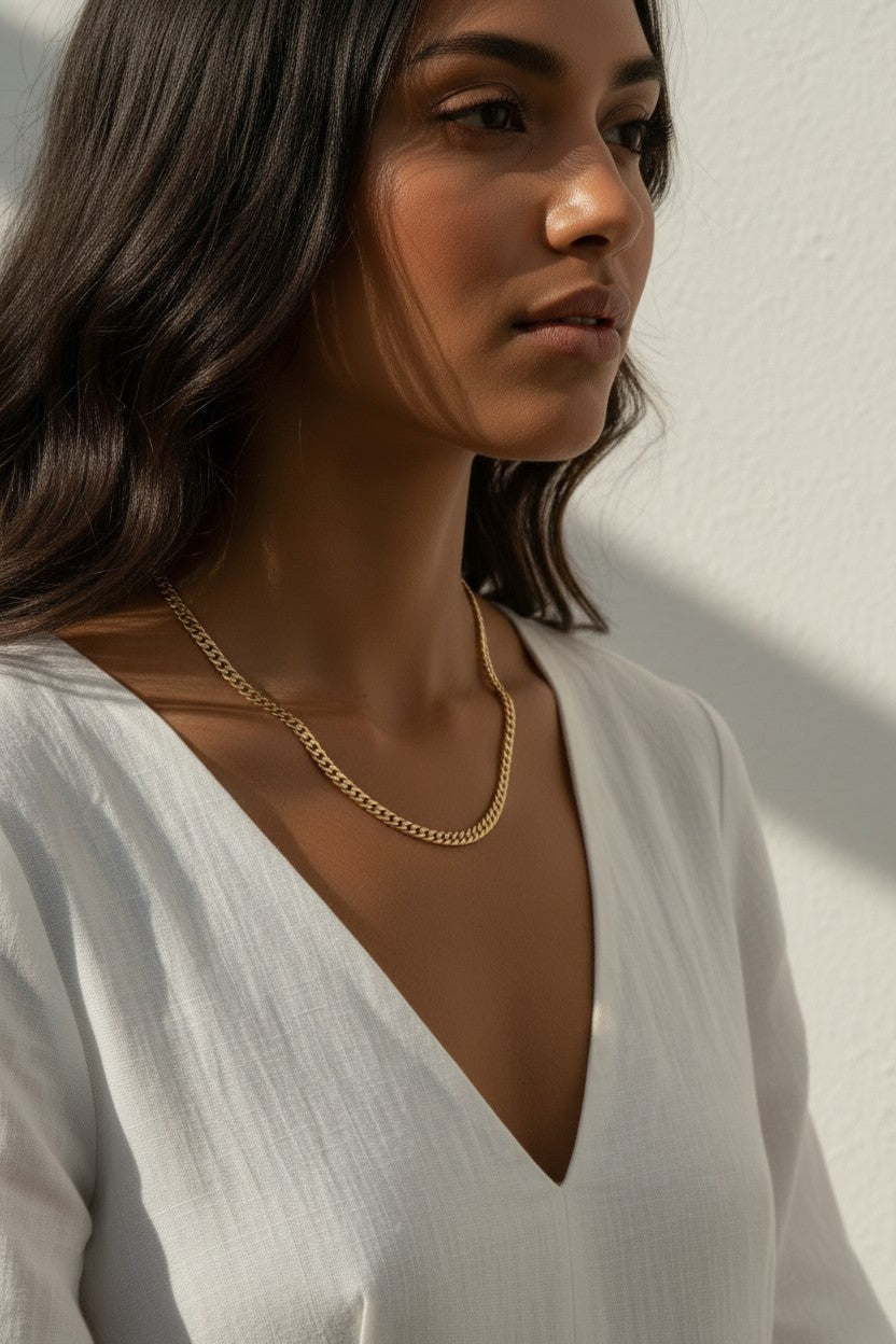 curb chain necklace on model, gold curb link necklace, classic chain necklace styled, flat link necklace worn, everyday gold necklace, polished chain necklace, layering necklace, curb chain necklace lifestyle