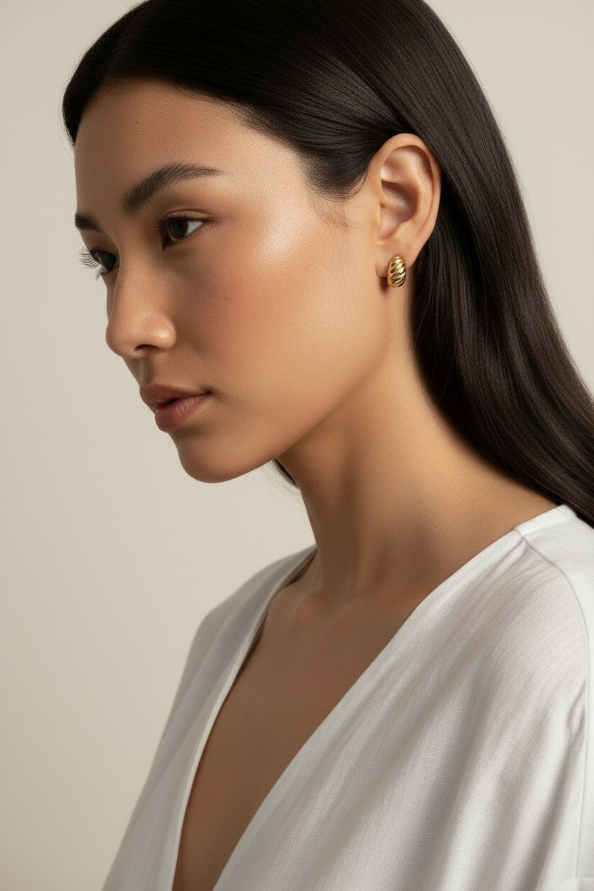 ribbed gold hoop earrings, fluted gold dome earrings, textured gold huggie hoops, ribbed earrings on model, gold hoop earrings close-up, sculptural gold earrings, minimalist ribbed hoops, everyday gold dome earrings