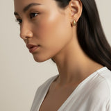 ribbed gold hoop earrings, fluted gold dome earrings, textured gold huggie hoops, ribbed earrings on model, gold hoop earrings close-up, sculptural gold earrings, minimalist ribbed hoops, everyday gold dome earrings