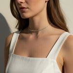 CZ tennis choker on model, baguette round cut necklace, sparkly choker close-up, stainless steel tennis necklace, cubic zirconia choker on model, statement choker necklace, layering CZ necklace, glamorous choker photo