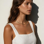 gold herringbone necklace on model, flat gold chain necklace, shiny herringbone chain, collarbone length necklace, minimalist gold necklace, everyday gold chain, layering chain necklace, flat snake chain, adjustable gold necklace, sleek gold jewelry, women’s gold chain necklace, summer gold necklace