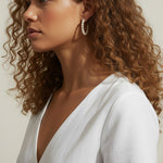 pearl hoop earrings worn, pearl earrings on model multiple hairstyles, classic pearl hoops lifestyle photo, wedding pearl earrings styled, freshwater pearl hoops fit, timeless pearl earrings close-up