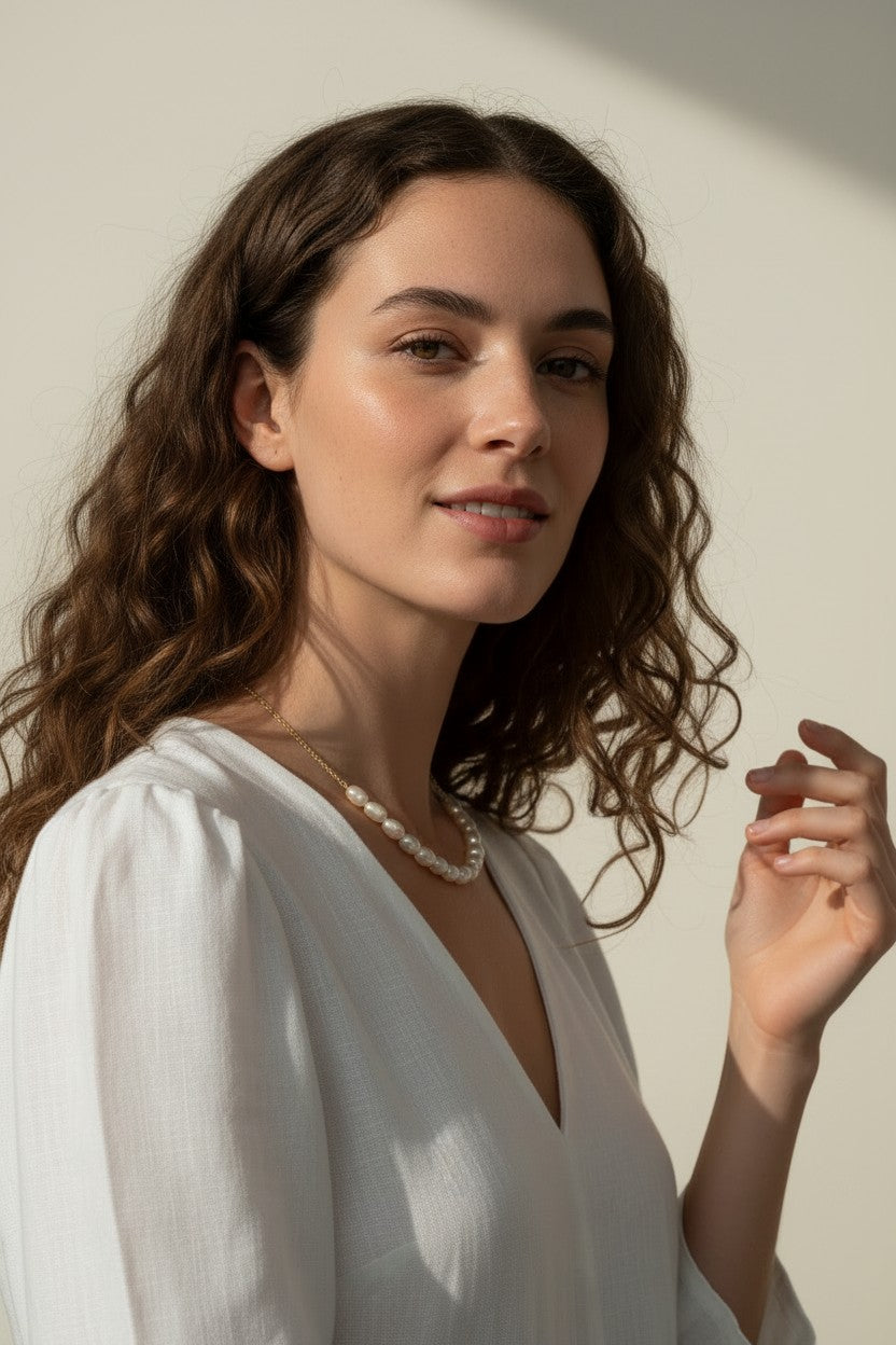 gold pearl cluster necklace on model, freshwater pearl necklace worn, modern pearl necklace styled, pearl necklace with white dress, gold chain pearl necklace, elegant pearl necklace lifestyle, dainty pearl cluster jewelry