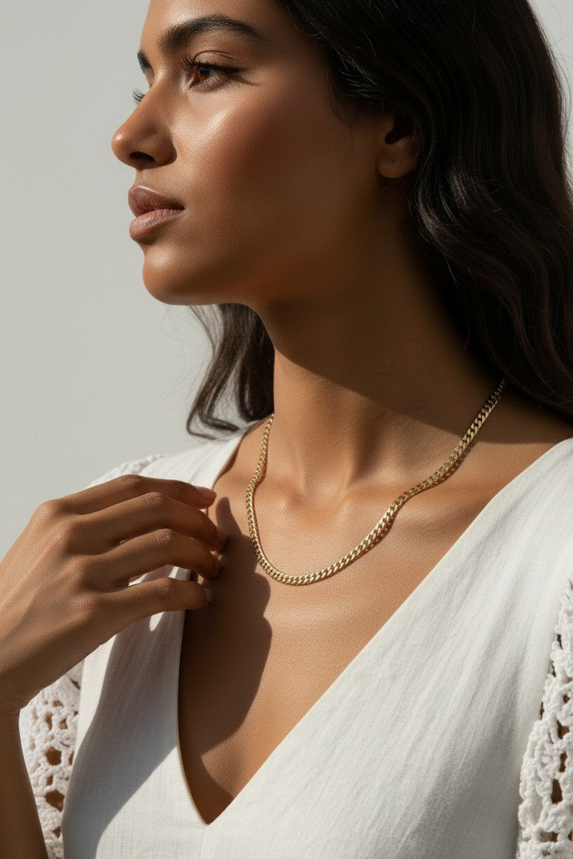 curb chain necklace on model, gold curb link necklace, classic chain necklace styled, flat link necklace worn, everyday gold necklace, polished chain necklace, layering necklace, curb chain necklace lifestyle