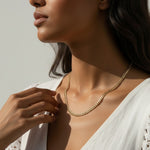 curb chain necklace on model, gold curb link necklace, classic chain necklace styled, flat link necklace worn, everyday gold necklace, polished chain necklace, layering necklace, curb chain necklace lifestyle