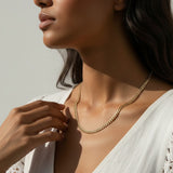 curb chain necklace on model, gold curb link necklace, classic chain necklace styled, flat link necklace worn, everyday gold necklace, polished chain necklace, layering necklace, curb chain necklace lifestyle