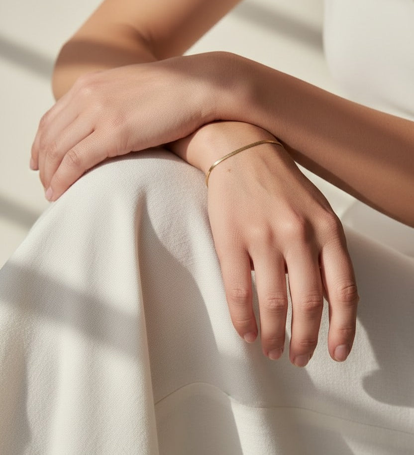 herringbone bracelet on model, thin gold bracelet wrist shot, minimalist gold bracelet, layering bracelet lifestyle, 18k gold overlay bracelet, everyday gold jewelry, herringbone chain wrist, delicate gold bracelet