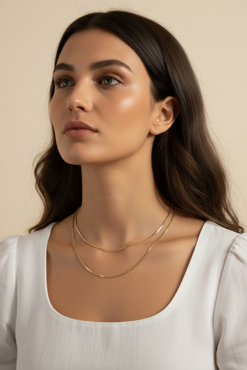 layered gold necklace set worn, double chain necklace styled, gold chain layering set fit, minimalist layered necklace lifestyle photo, disc chain and cable chain necklace, gold necklace stack close-up