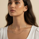 layered gold necklace set worn, double chain necklace styled, gold chain layering set fit, minimalist layered necklace lifestyle photo, disc chain and cable chain necklace, gold necklace stack close-up