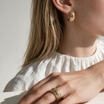 chunky gold hoop earrings on model, dome hoop earrings, crystal c hoop earrings, thick gold huggie earrings, sparkly gold hoops, statement huggie earrings, matching ring and earrings set, chunky gold dome ring, cubic zirconia hoop earrings, gold dome earrings, bold gold jewelry set, women’s chunky hoops