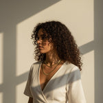 layered herringbone necklaces, double herringbone chain, gold chain layering on model, 18k gold overlay necklace set, herringbone necklace editorial, layered gold necklaces sunset, mixed length herringbone chains, gold chain styling inspiration