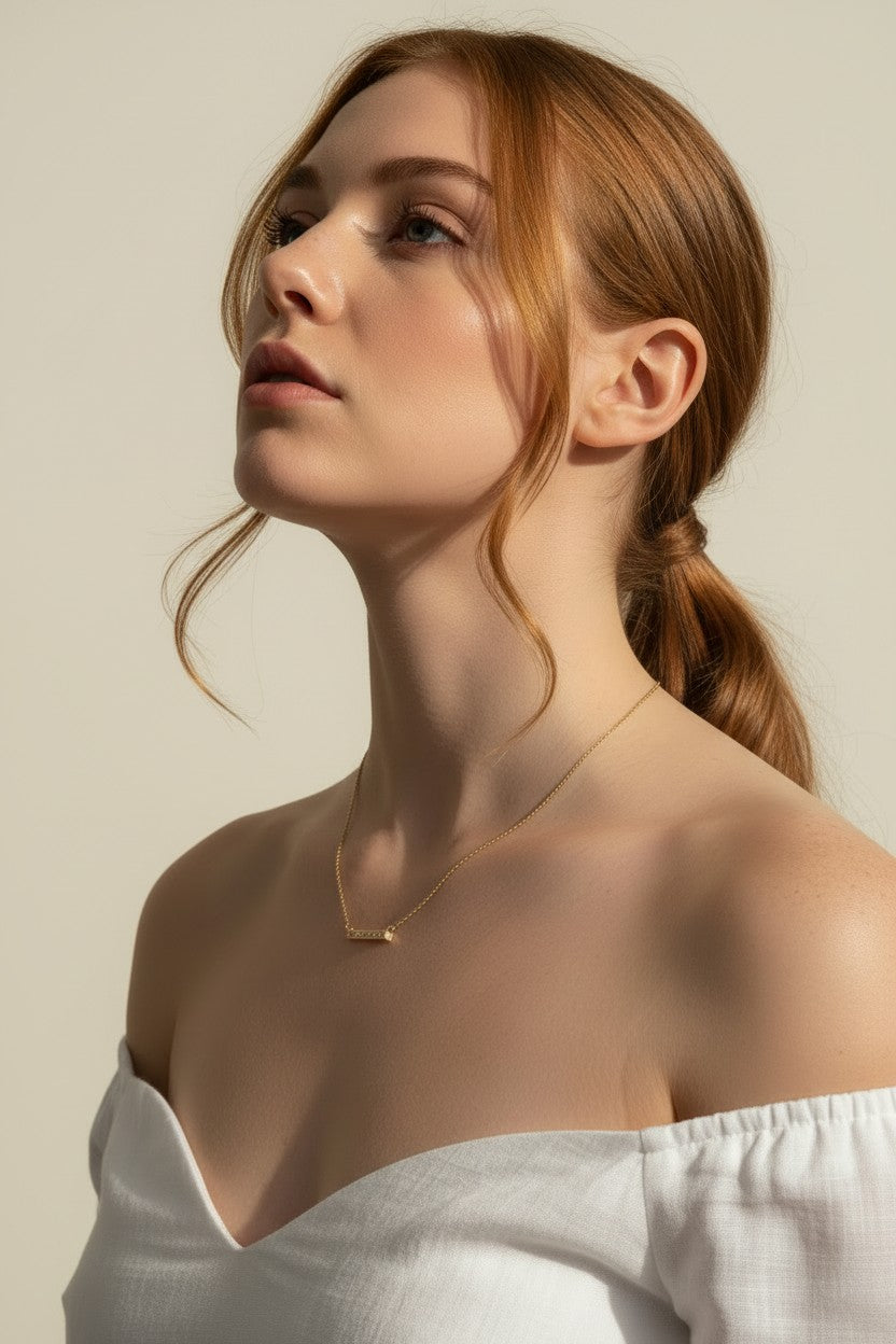 baguette bar necklace on model, clear baguette pendant necklace, gold bar necklace with stones, delicate layering necklace, minimalist sparkle necklace, baguette pendant on collarbone, gold chain bar necklace, dainty statement necklace