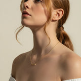 baguette bar necklace on model, clear baguette pendant necklace, gold bar necklace with stones, delicate layering necklace, minimalist sparkle necklace, baguette pendant on collarbone, gold chain bar necklace, dainty statement necklace