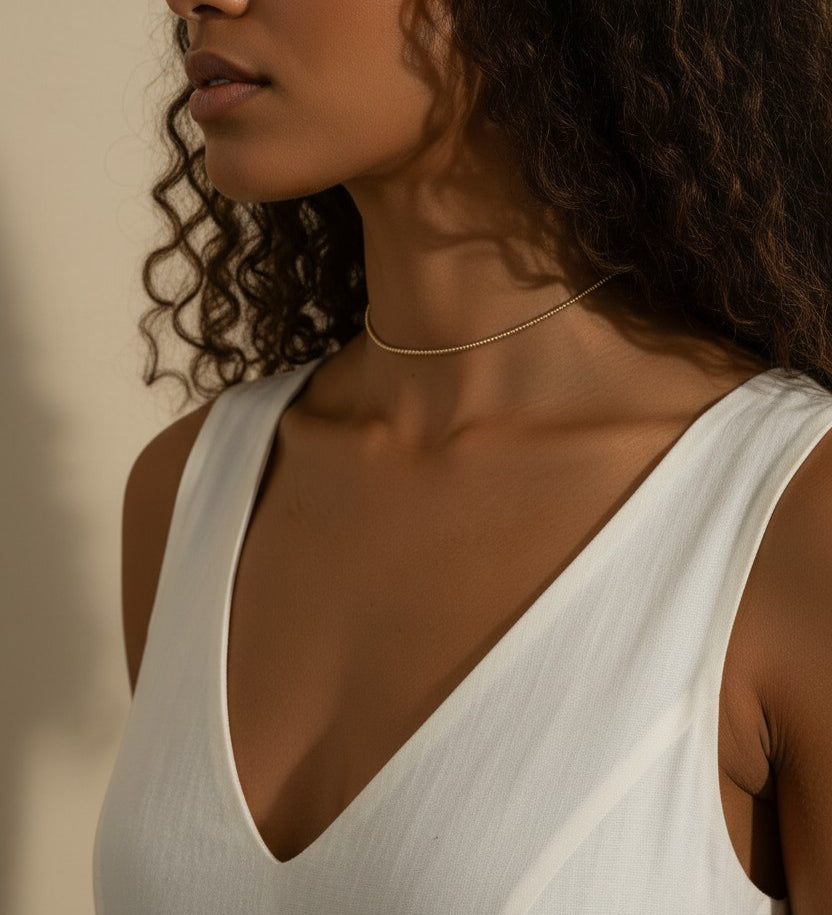 gold beaded choker, dainty gold choker necklace, beaded chain choker on model, minimalist gold choker, layering choker necklace, thin gold choker, delicate beaded necklace, gold choker close-up