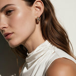 chunky gold hoop earrings on model, dome hoop earrings, crystal c hoop earrings, thick gold huggie earrings, sparkly gold hoops, statement huggie earrings, matching ring and earrings set, chunky gold dome ring, cubic zirconia hoop earrings, gold dome earrings, bold gold jewelry set, women’s chunky hoops