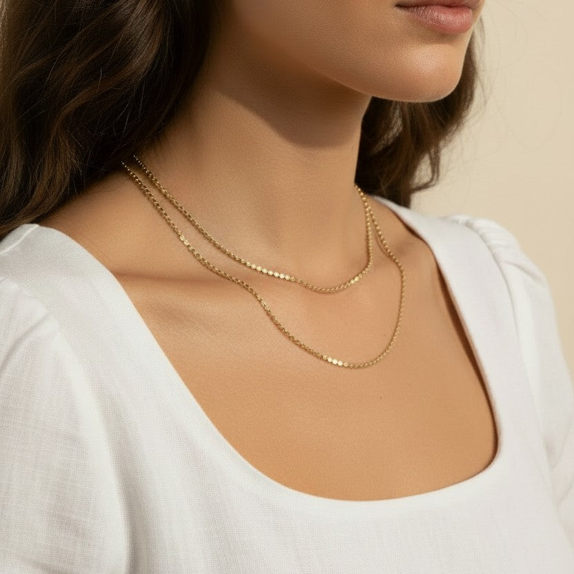 layered gold necklace set worn, double chain necklace styled, gold chain layering set fit, minimalist layered necklace lifestyle photo, disc chain and cable chain necklace, gold necklace stack close-up