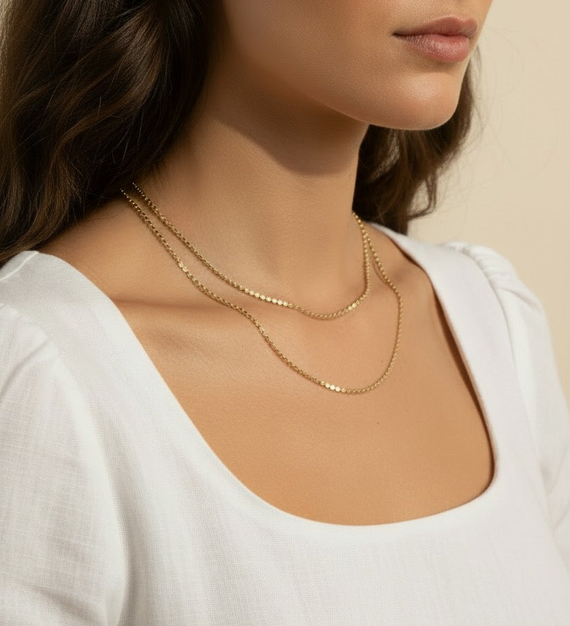 layered gold necklace set worn, double chain necklace styled, gold chain layering set fit, minimalist layered necklace lifestyle photo, disc chain and cable chain necklace, gold necklace stack close-up