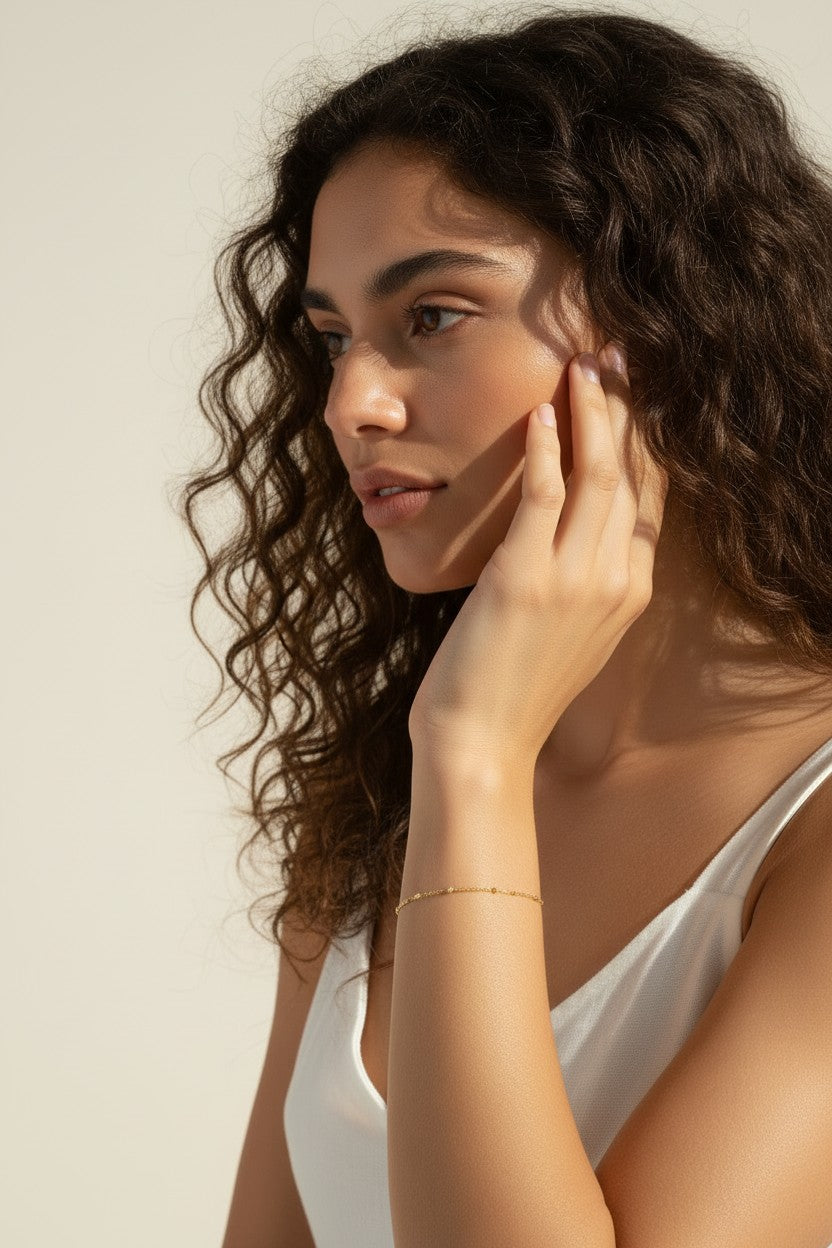 station chain bracelet on model, dainty gold bracelet lifestyle, minimalist gold bracelet, delicate chain bracelet wrist shot, 18k gold bracelet, everyday layering bracelet, gold disc bracelet, simple gold jewelry
