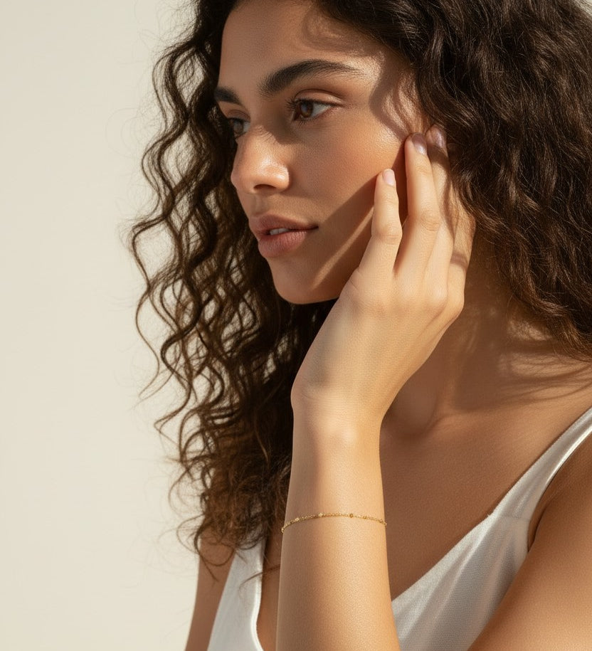 station chain bracelet on model, dainty gold bracelet lifestyle, minimalist gold bracelet, delicate chain bracelet wrist shot, 18k gold bracelet, everyday layering bracelet, gold disc bracelet, simple gold jewelry
